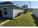 Side yard with planter boxes and foliage extending to the fence at 137 Juniper Loop, Ocala, FL 34480