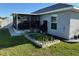 Lawn with screened in patio, along with planter boxes and storage at 137 Juniper Loop, Ocala, FL 34480