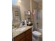 Bright bathroom featuring a granite counter, a shower/tub combo, and a storage shelf at 137 Juniper Loop, Ocala, FL 34480