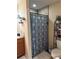Bright bathroom featuring a tiled shower with a decorative curtain and adjacent vanity at 137 Juniper Loop, Ocala, FL 34480