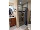 Bathroom with an updated vanity, shelving, and walk-in shower with neutral-toned tile at 137 Juniper Loop, Ocala, FL 34480