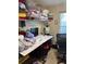 Bedroom used for storage, featuring a window, a desk, and personal items throughout the room at 137 Juniper Loop, Ocala, FL 34480