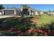 Charming single-story home with lovely landscaping, a green lawn, and an attached garage at 137 Juniper Loop, Ocala, FL 34480