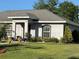Charming single-story home with lovely landscaping, a green lawn, and an attached garage at 137 Juniper Loop, Ocala, FL 34480