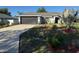 Charming single-story home with a well-manicured lawn and a spacious two-car garage at 137 Juniper Loop, Ocala, FL 34480