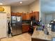 Well-lit kitchen featuring stainless steel appliances, tile floors, and granite countertops at 137 Juniper Loop, Ocala, FL 34480
