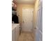 Laundry room featuring white washer and dryer with shelving for ample storage at 137 Juniper Loop, Ocala, FL 34480