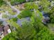 Birds eye view of a house surrounded by mature trees in a residential neighborhood at 1505 Se 27Th Ter, Ocala, FL 34471