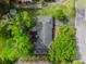 An aerial view of the house showing a driveway and mature trees at 1505 Se 27Th Ter, Ocala, FL 34471