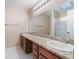 Bathroom featuring a double sink vanity with granite countertops and a glass-enclosed shower at 1505 Se 27Th Ter, Ocala, FL 34471