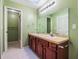 Bathroom featuring a double sink vanity and a shower with a glass door at 1505 Se 27Th Ter, Ocala, FL 34471