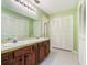 Well-lit bathroom featuring a double sink vanity, tiled floor, and ample storage space at 1505 Se 27Th Ter, Ocala, FL 34471