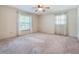 Well-lit bedroom with large windows and a ceiling fan at 1505 Se 27Th Ter, Ocala, FL 34471