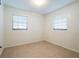 A bright bedroom featuring tile floors and two windows providing plenty of natural light at 1505 Se 27Th Ter, Ocala, FL 34471