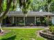 A well-maintained home with stone accents, surrounded by lush greenery, offering an inviting curb appeal at 1505 Se 27Th Ter, Ocala, FL 34471