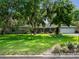 Well-maintained home featuring a lush green lawn and mature trees, complemented by a two-car garage at 1505 Se 27Th Ter, Ocala, FL 34471