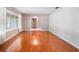 Spacious living room with gleaming hardwood floors, large windows, and neutral paint creating a bright and inviting space at 1505 Se 27Th Ter, Ocala, FL 34471