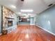 Spacious living room featuring a stone fireplace and gleaming hardwood floors at 1505 Se 27Th Ter, Ocala, FL 34471