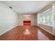 Bright living room with hardwood floors, a bay window and neutral paint leading to the dining room at 1505 Se 27Th Ter, Ocala, FL 34471