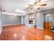 Expansive living room with hardwood floors, a stone fireplace, and ample natural light, perfect for relaxation at 1505 Se 27Th Ter, Ocala, FL 34471