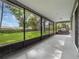 A screened patio that offers peaceful views of the expansive, well-maintained backyard at 1505 Se 27Th Ter, Ocala, FL 34471