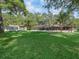 Beautiful backyard with a large lawn, sheds, and a pool enclosed for safety and relaxation at 16 Northern Dancer Dr, Ocala, FL 34482