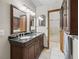 Bathroom featuring double sinks with granite counters, cabinet storage and tiled floors at 16 Northern Dancer Dr, Ocala, FL 34482