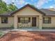 Charming front porch with comfortable seating, creating a welcoming entrance to this lovely home at 16 Northern Dancer Dr, Ocala, FL 34482