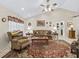 Bright living room featuring a vaulted ceiling, plush seating, and ample natural light for a comfortable living space at 16 Northern Dancer Dr, Ocala, FL 34482