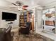 Cozy living room featuring comfortable leather chairs, large television, and a ceiling fan at 16 Northern Dancer Dr, Ocala, FL 34482