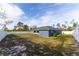 Back yard with lawn, fence and view of the home at 16201 Sw 47Th Ter, Ocala, FL 34473