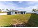 Spacious back yard with lawn, privacy fence and view of the screened-in patio at 16201 Sw 47Th Ter, Ocala, FL 34473