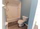 Tiled bathroom featuring a shower and tub combination, toilet, and modern flooring at 16201 Sw 47Th Ter, Ocala, FL 34473