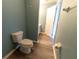 Clean bathroom featuring a toilet, open doorway, and wood-look flooring at 16201 Sw 47Th Ter, Ocala, FL 34473