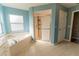 Bright bathroom with a soaking tub under a window and glass enclosed shower at 16201 Sw 47Th Ter, Ocala, FL 34473