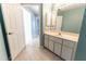 Well-lit bathroom featuring a vanity with ample storage space and neutral-toned tile flooring at 16201 Sw 47Th Ter, Ocala, FL 34473