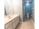 Well-lit bathroom featuring a spacious vanity and neutral-toned tile flooring and a view of the toilet and shower at 16201 Sw 47Th Ter, Ocala, FL 34473