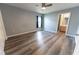 Bedroom featuring laminate flooring, a ceiling fan, natural light, and an en-suite bathroom at 16201 Sw 47Th Ter, Ocala, FL 34473