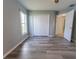 Bedroom features wood floors, closet and an open white door at 16201 Sw 47Th Ter, Ocala, FL 34473