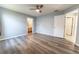 Bedroom featuring laminate flooring, a ceiling fan, natural light, and access to two different rooms at 16201 Sw 47Th Ter, Ocala, FL 34473