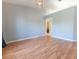 Spacious bedroom with light-colored walls, wood floors, and a doorway leading to another room at 16201 Sw 47Th Ter, Ocala, FL 34473