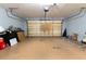Clean garage with neutral colored walls, finished floor, and insulated garage door at 16201 Sw 47Th Ter, Ocala, FL 34473