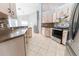 Updated kitchen with stainless steel appliances, tiled backsplash, and light-colored cabinets at 16201 Sw 47Th Ter, Ocala, FL 34473