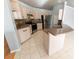 Modern kitchen with stainless steel appliances, light cabinets, and a breakfast bar area at 16201 Sw 47Th Ter, Ocala, FL 34473