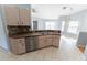 Bright kitchen featuring stainless steel dishwasher, double sink, and light wood cabinets at 16201 Sw 47Th Ter, Ocala, FL 34473