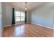 Bright living room with wood floors, neutral walls, and a large bay window at 16201 Sw 47Th Ter, Ocala, FL 34473