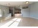 Open-concept living room and kitchen area with tiled flooring and a breakfast bar at 16201 Sw 47Th Ter, Ocala, FL 34473