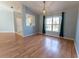 Open-concept living area featuring wood floors, neutral walls, and a bright bay window at 16201 Sw 47Th Ter, Ocala, FL 34473