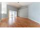 Bright living room with wood floors, neutral walls, and a sliding glass door to the outdoor patio at 16201 Sw 47Th Ter, Ocala, FL 34473