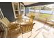 View of a tiled, screened porch with outdoor table and four chairs at 16201 Sw 47Th Ter, Ocala, FL 34473